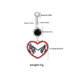 Dettaglio piercing ombelico a cuore gotico con mani di scheletro e strass rossi