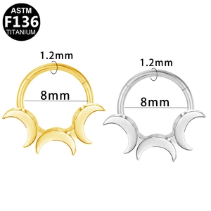 Detailed view of G23 titanium septum rings with triple crescent moon design in gold and silver
