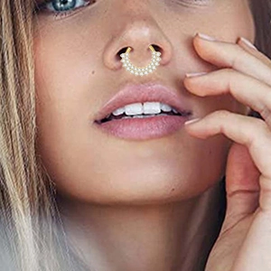 Macro view of a gold-plated G23 titanium nose ring featuring double rows of zircon crystals