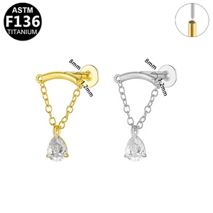 Detail of G23 titanium chain labret stud with teardrop zircon in gold and silver