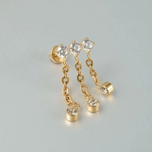 Detail of gold chain stud earring with three zircons and hanging tassel dangles