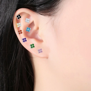 Detail of G23 titanium clover stud earrings with colorful zircon inlay for ear piercings