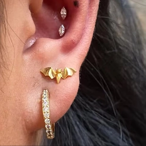 G23 titanium piercing jewelry set featuring gold bat stud and marquise gem earrings