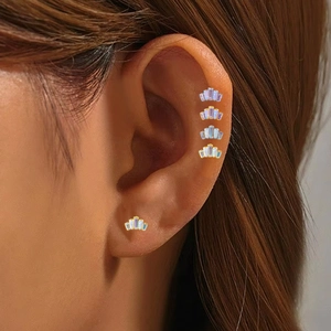 Macro shot of G23 titanium fan-shaped lip studs with colorful crystal rectangle zircons
