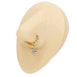Close-up of golden nose ring with white rhinestones and a snake-shaped pendant
