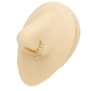 Detail of gold nose hoop with sparkling pavé star pendant on silicone nose model