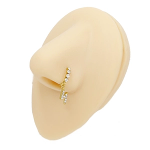 Detail of golden stainless steel nose ring with lightning bolt charm and clear rhinestones