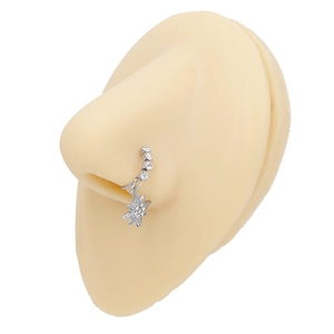 Detail of silver nose ring with star-shaped zircon pendant on a silicone nose model