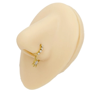 Detail of gold nose ring with sparkling star pendant and zircon stones on a model