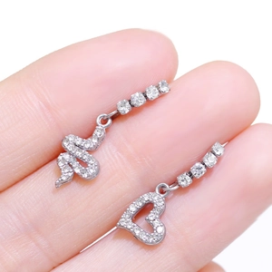 Silver asymmetrical earrings featuring a zircon-studded snake and open heart design