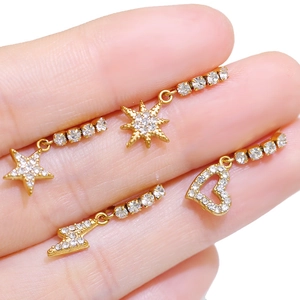 Gold celestial body piercings with heart moon star lightning charms and zircons