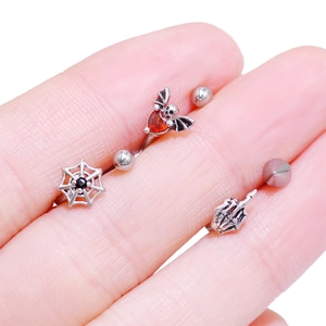 Gothic body piercing set with spider web, bat and skeletal hand designs in silver finish