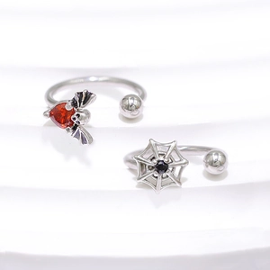 Detailed macro view of Gothic bat wings with red heart stone and spider web nose ring