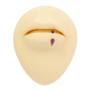 Detail of gothic spider web style coffin lip stud with red enamel cross on silicone model