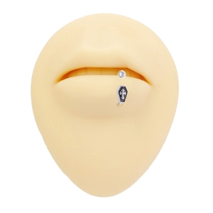 Detail shot of a gothic coffin lip ring with cross motif on a silicone model