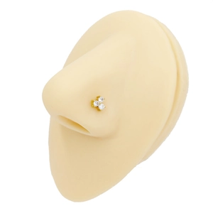 Detail of gold clover nose stud with clear zircons on a realistic nose display model