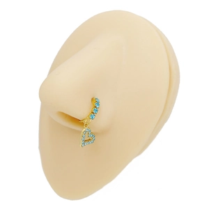 Detail view of a gold-plated nose ring featuring blue zircon and a heart pendant