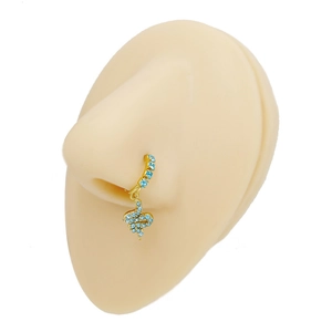 Detail view of a gold snake nose ring with light blue zircon stones on a skin model