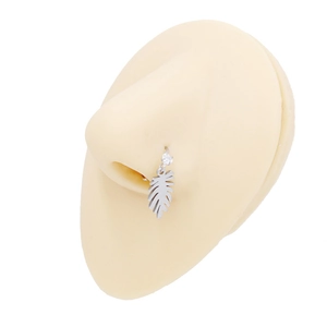 Detail of silver nose ring featuring a feather pendant with a sparkling crystal stone