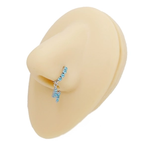 Macro shot of silver lightning nose ring with blue zircons on silicone model