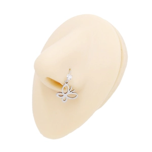 Detail of silver butterfly nose ring with zircon stone on a silicone model piercing