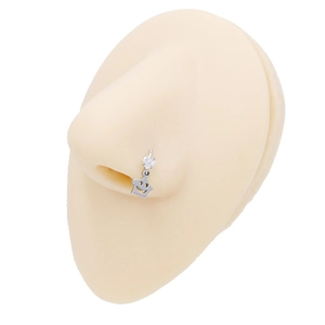 Surgical steel nose stud featuring a sparkling star charm with a cutout smiley face design