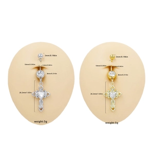 Cross belly ring with heart zircon in gold and silver finish on body model