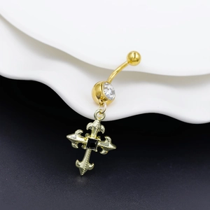 Macro shot of gothic cross belly button ring with gold finish and black center stone