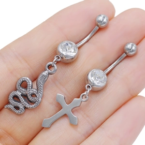 Minimalist stainless steel belly rings with snake and cross pendants featuring CZ stones