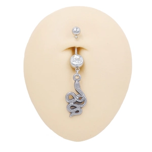 Detail of silver stainless steel belly ring with zircon and snake pendant on model