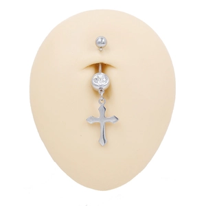 Detailed shot of a silver navel ring with a cross pendant and round zircon on a skin model