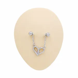 Macro detail of silver heart nipple ring with rhinestones on a silicone model