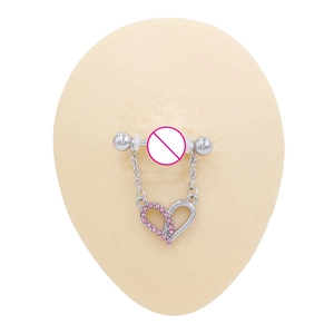Detail of nipple ring with silver chain and heart pendant featuring pink rhinestones
