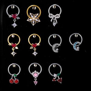 Detailed grid of stainless steel clicker nose rings with heart and flower crystal charms