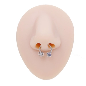 Detail view of surgical steel horseshoe nose ring with spider and web charm design