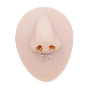 Detail view of horseshoe nose ring with crescent moon ends on a silicone nose model