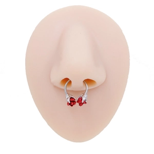 Detail of silver horseshoe septum ring with red rose studs on a silicone model