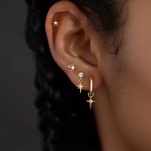 Set de pendientes de estrella en titanio dorado con circonitas en modelo