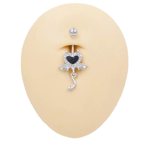 Macro detail of devil heart belly ring with black heart and wings on silicone model