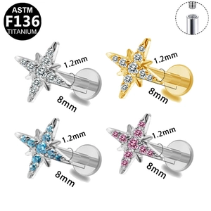 Detailed view of ASTM F136 titanium star labret studs with internal threading and zircon