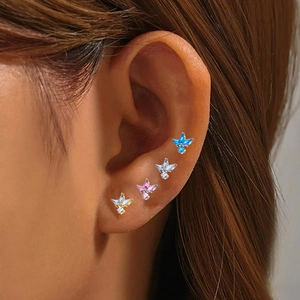 Detailed view of four colorful butterfly labret studs with zircon on ear cartilage