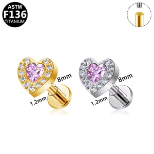 Macro view of heart-shaped titanium piercing stud with pink zircon and internal threading