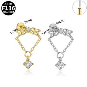 Detailed view of F136 titanium labret studs with hanging chain and crystal charms