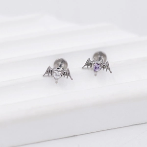 Gothic G23 titanium labret studs with bat wings and heart zircon in a minimalist display