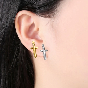 Detailed view of silver and gold dagger stud earrings made of F136 titanium alloy