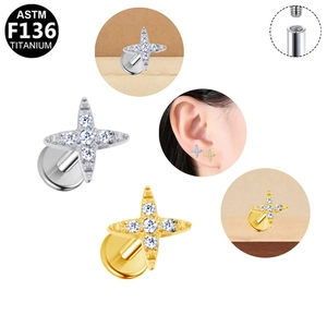 Detailed view of F136 titanium internally threaded four-pointed star stud with zircon