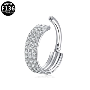 Detail view of F136 titanium septum ring with triple rows of paved white zircons