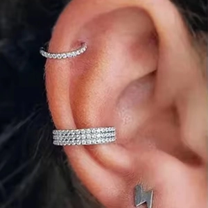 Titanium piercing set featuring layered pave hoop and lightning bolt stud earring