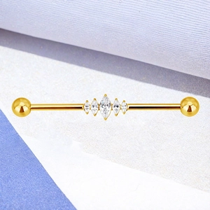 Macro-opname van gouden industrial barbell met marquise zirkoon en gepolijste finish