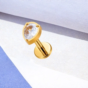 Macro shot of gold plated titanium labret stud with a pear cut cubic zirconia stone